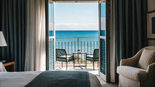 Elegant hotel room with private balcony overlooking Terracina beach and blue Mediterranean Sea