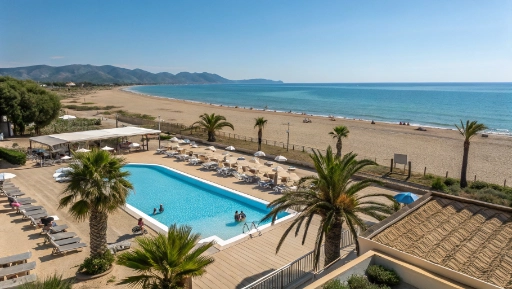 Luxury beach resort swimming pool overlooking Terracina sandy beach and blue Mediterranean Sea