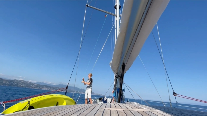 Family on boat excursion approaching sea caves near Terracina with clear turquoise water